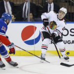 
              Chicago Blackhawks center Max Domi (13) passes against New York Rangers right wing Julien Gauthier (12) during the second period of an NHL hockey game, Saturday, Dec. 3, 2022, in New York. (AP Photo/Jessie Alcheh)
            
