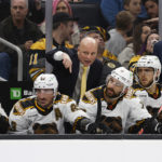 
              Boston Bruins head coach Jim Montgomery talks with his players on the bench during the second period of an NHL hockey game against the Colorado Avalanche Saturday, Dec. 3, 2022, in Boston. (AP Photo/Winslow Townson)
            