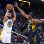 
              Golden State Warriors guard Stephen Curry (30) shoots over Indiana Pacers center Myles Turner (33) during the first half of an NBA basketball game in Indianapolis, Wednesday, Dec. 14, 2022. (AP Photo/Michael Conroy)
            
