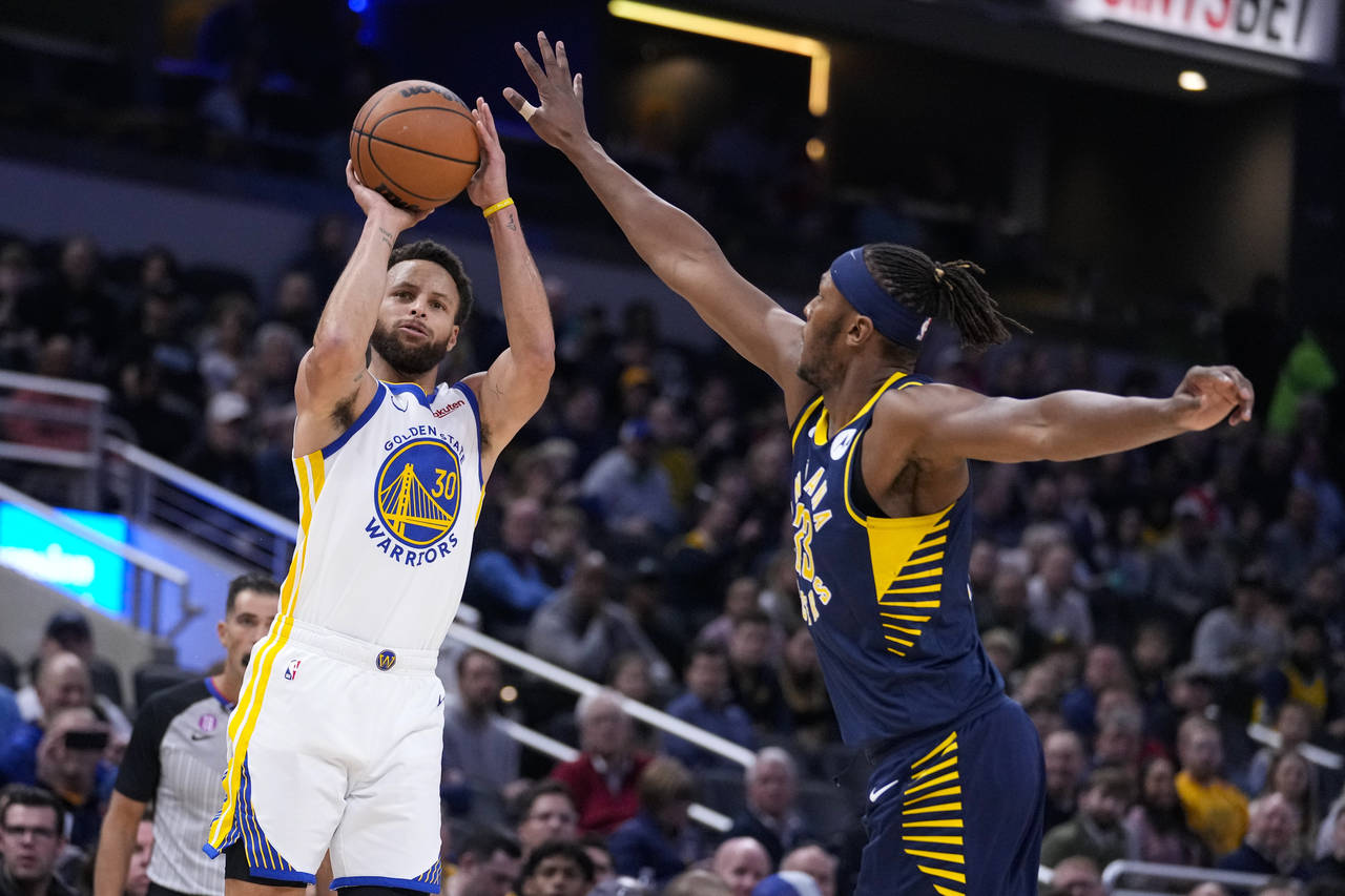 Golden State Warriors guard Stephen Curry (30) shoots over Indiana Pacers center Myles Turner (33) ...