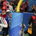 
              Georgia wide receiver Arian Smith (11) celebrates his touchdown against Ohio State during the second half of the Peach Bowl NCAA college football semifinal playoff game, Saturday, Dec. 31, 2022, in Atlanta. (AP Photo/Brynn Anderson)
            
