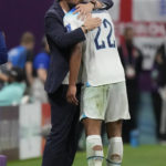 
              England's head coach Gareth Southgate embraces Jude Bellingham after replacing him for Mason Mount during the World Cup round of 16 soccer match between England and Senegal, at the Al Bayt Stadium in Al Khor, Qatar, Sunday, Dec. 4, 2022. (AP Photo/Frank Augstein)
            