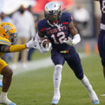 
              Jackson State's Travis Hunter (12) holds on to a pass as Southern University defensive back Jordan Carter (7) reaches out in a tackle attempt during the first half of the Southwestern Athletic Conference championship NCAA college football game Saturday, Dec. 3, 2022, in Jackson, Miss. (AP Photo/Rogelio V. Solis)
            