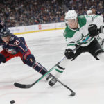 
              Dallas Stars' Nils Lundkvist, right, passes the puck past Columbus Blue Jackets' Patrik Laine during the third period of an NHL hockey game on Monday, Dec. 19, 2022, in Columbus, Ohio. (AP Photo/Jay LaPrete)
            
