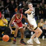 
              North Carolina State guard Saniya Rivers steals the ball from Iowa guard Caitlin Clark, right, during the first half of an NCAA college basketball game, Thursday, Dec. 1, 2022, in Iowa City, Iowa. (AP Photo/Charlie Neibergall)
            