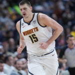 
              Denver Nuggets center Nikola Jokic heads back on defense during the second half of the team's NBA basketball game against the Memphis Grizzlies on Tuesday, Dec. 20, 2022, in Denver. (AP Photo/David Zalubowski)
            