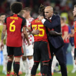 
              Belgium's head coach Roberto Martinez embraces Belgium's Jeremy Doku after their team was defeated at the World Cup group F soccer match between Croatia and Belgium at the Ahmad Bin Ali Stadium in Al Rayyan, Qatar, Thursday, Dec. 1, 2022. (AP Photo/Thanassis Stavrakis)
            
