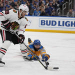 
              Chicago Blackhawks' Andreas Athanasiou (89) controls the puck as St. Louis Blues' Robert Bortuzzo defends during the third period of an NHL hockey game Thursday, Dec. 29, 2022, in St. Louis. (AP Photo/Jeff Roberson)
            
