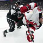
              Los Angeles Kings right wing Adrian Kempe, left, battles for the puck with New Jersey Devils left wing Ondrej Palat, right, during the second period of an NHL hockey game Saturday, Jan. 14, 2023, in Los Angeles. (AP Photo/Mark J. Terrill)
            