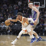 
              Atlanta Hawks guard Trae Young (11) is fouled by Sacramento Kings guard Kevin Huerter during the second half in an NBA basketball game in Sacramento, Calif., Wednesday, Jan. 4, 2023. (AP Photo/José Luis Villegas)
            