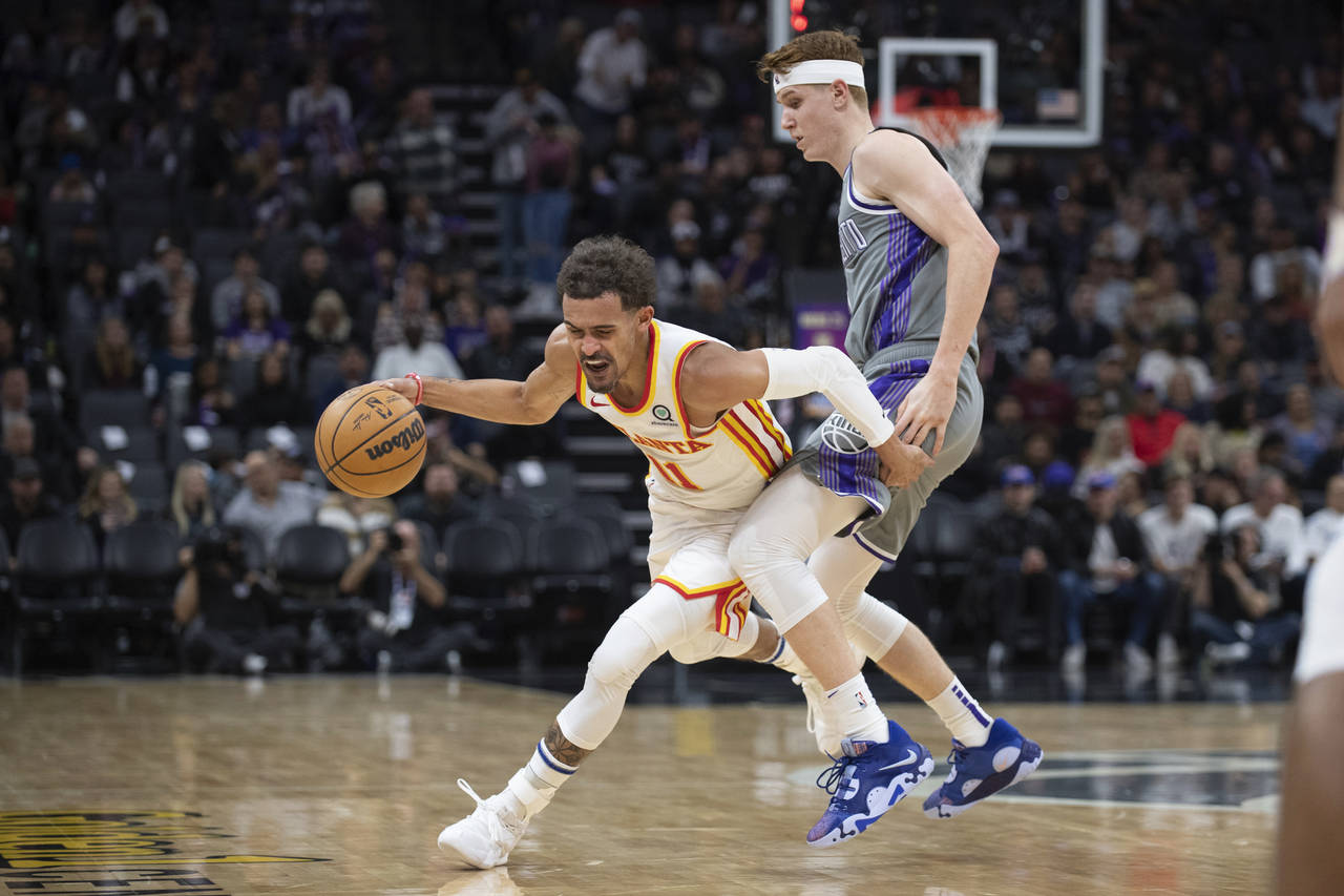 Atlanta Hawks guard Trae Young (11) is fouled by Sacramento Kings guard Kevin Huerter during the se...