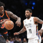 
              New York Knicks forward Julius Randle drives against Brooklyn Nets guard Kyrie Irving (11) during the first half of an NBA basketball game, Saturday, Jan. 28, 2023, in New York. (AP Photo/Mary Altaffer)
            