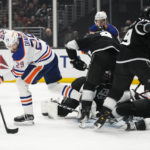 
              Edmonton Oilers' Leon Draisaitl (29) moves the puck as Los Angeles Kings players are tangled up around the net during the first period of an NHL hockey game Monday, Jan. 9, 2023, in Los Angeles. (AP Photo/Jae C. Hong)
            