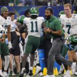 
              Tulane defensive back Jarius Monroe (11) in congratulated on his teams bench after intercepting a pass during the first half of the Cotton Bowl NCAA college football game against Southern California, Monday, Jan. 2, 2023, in Arlington, Texas. (AP Photo/Sam Hodde)
            