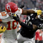 
              Kansas City Chiefs running back Isiah Pacheco (10) struggles for yardage as Las Vegas Raiders safety Duron Harmon (30) defends during the second half of an NFL football game Saturday, Jan. 7, 2023, in Las Vegas. (AP Photo/David Becker)
            
