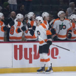 
              Philadelphia Flyers left wing Noah Cates (49) celebrates with teammates after scoring against the Minnesota Wild during the first period of an NHL hockey game Thursday, Jan. 26, 2023, in St. Paul, Minn. (AP Photo/Abbie Parr)
            