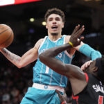
              Charlotte Hornets guard LaMelo Ball (1) is called for an offensive foul as gets his hand up on Toronto Raptors forward Pascal Siakam's face during the second half of an NBA basketball game in Toronto on Thursday, Jan. 12, 2023. (Frank Gunn/The Canadian Press via AP)
            
