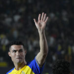 
              Cristiano Ronaldo greets Saudi fans during his official unveiling as a new member of Al Nassr soccer club in in Riyadh, Saudi Arabia, Tuesday, Jan. 3, 2023. Ronaldo, who has won five Ballon d'Ors awards for the best soccer player in the world and five Champions League titles, will play outside of Europe for the first time in his storied career. (AP Photo/Amr Nabil)
            
