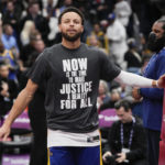 
              Golden State Warriors guard Stephen Curry (30) warms up in a shirt honoring Martin Luther King Jr. before an NBA basketball game against the Washington Wizards, Monday, Jan. 16, 2023, in Washington. (AP Photo/Jess Rapfogel)
            
