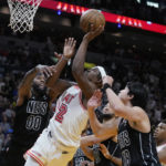
              Miami Heat forward Jimmy Butler (22) attempts a shot during final seconds of the second half of an NBA basketball game against the Brooklyn Nets, Sunday, Jan. 8, 2023, in Miami. (AP Photo/Wilfredo Lee)
            