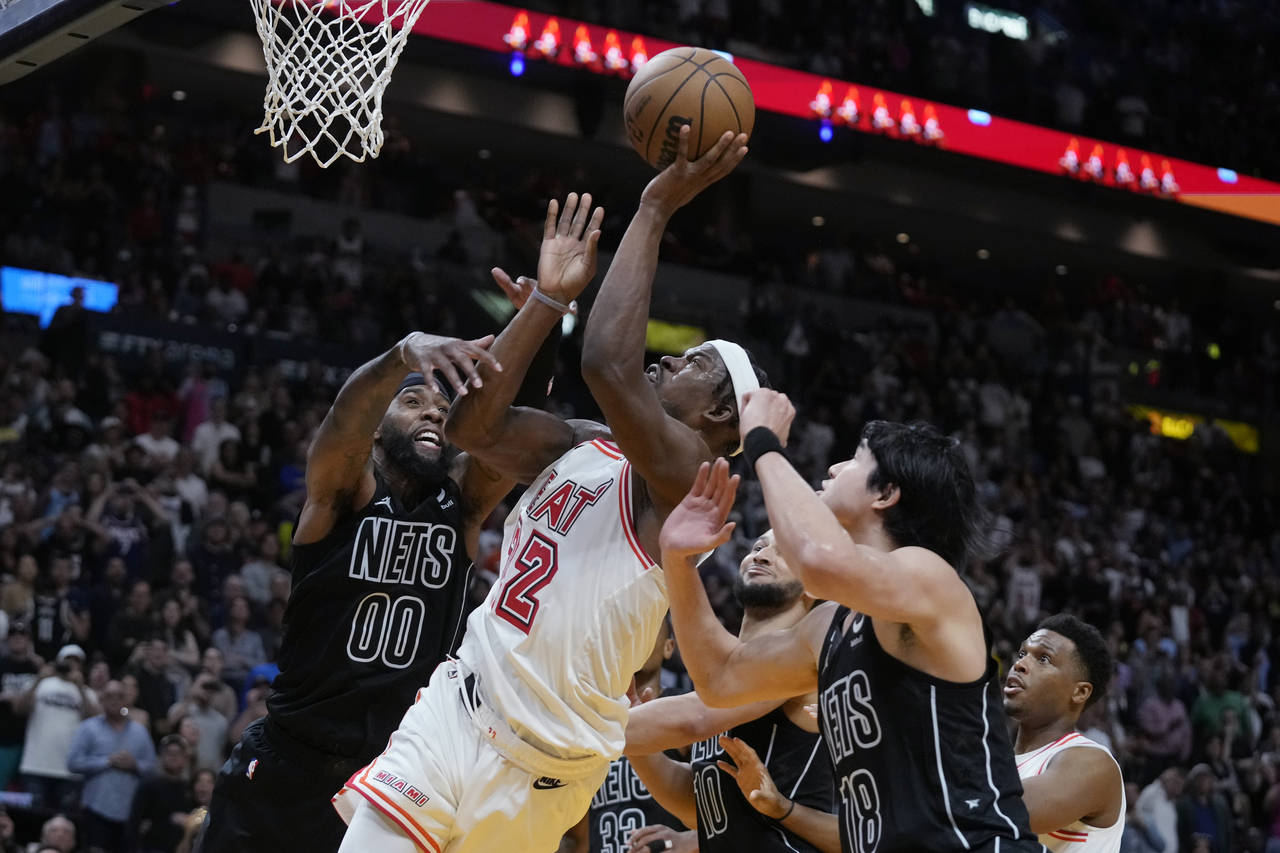 Miami Heat forward Jimmy Butler (22) attempts a shot during final seconds of the second half of an ...