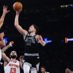
              San Antonio Spurs' Doug McDermott (17) shoots over New York Knicks' Evan Fournier (13) and Jericho Sims during the first half of an NBA basketball game Wednesday, Jan. 4, 2023, in New York. (AP Photo/Frank Franklin II)
            