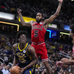 
              Indiana Pacers forward Jalen Smith (25) looks to shoot in front of Chicago Bulls forward Derrick Jones Jr. (5) during the first half of an NBA basketball game in Indianapolis, Tuesday, Jan. 24, 2023. (AP Photo/Michael Conroy)
            