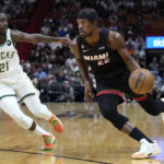 
              Miami Heat forward Jimmy Butler (22) drives to the basket past Milwaukee Bucks guard Jrue Holiday (21) during the first half of an NBA basketball game, Thursday, Jan. 12, 2023, in Miami. (AP Photo/Wilfredo Lee)
            