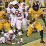 
              FILE - Southern Miss running back Frank Gore Jr. (3) scores while filling in as quarterback against Liberty linebacker Ahmad Walker (34) dives after him during the second half of an NCAA football game on Friday, Sept. 3, 2022, in Hattiesburg, Miss. The son of one of the NFL’s most prolific running backs made quite a name for himself this bowl season. (AP Photo/Matthew Hinton, File)
            