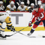 
              Washington Capitals right wing T.J. Oshie (77) skates with the puck against Pittsburgh Penguins defenseman Marcus Pettersson (28) during the first period of an NHL hockey game Thursday, Jan. 26, 2023, in Washington. (AP Photo/Nick Wass)
            