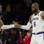 
              Los Angeles Lakers forward LeBron James, right, and forward Troy Brown Jr. celebrate after defeating the Portland Trail Blazers in an NBA basketball game in Portland, Ore., Sunday, Jan. 22, 2023. (AP Photo/Craig Mitchelldyer)
            