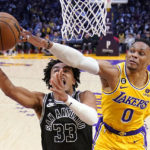 
              San Antonio Spurs guard Tre Jones, left, shoots as Los Angeles Lakers guard Russell Westbrook defends during the first half of an NBA basketball game Wednesday, Jan. 25, 2023, in Los Angeles. (AP Photo/Mark J. Terrill)
            