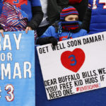 
              Fans hold signs displaying the number 3 in support of safety Damar Hamlin during practices before an NFL football game against the New England Patriots, Sunday, Jan. 8, 2023, in Orchard Park, N.Y. Hamlin remains hospitalized after suffering a catastrophic on-field collapse in the team's previous game against the Cincinnati Bengals. (AP Photo/Jeffrey T. Barnes)
            