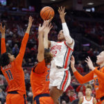 
              Ohio State forward Cotie McMahon (32) shoots between Illinois guard Jada Peebles (11), forward Brynn Shoup-Hill (23) and forward Kendall Bostic (44) during the second half of an NCAA college basketball game in Columbus, Ohio, Sunday, Jan. 8, 2023. (AP Photo/Paul Vernon)
            