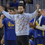 
              Injured Golden State Warriors guard Stephen Curry reacts from the sideline during the second half of the team's NBA basketball game against the Detroit Pistons in San Francisco, Wednesday, Jan. 4, 2023. (AP Photo/Jeff Chiu)
            