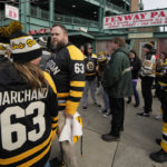 
              Hockey fans wait for the gates to open prior to the NHL Winter Classic hockey game between the Pittsburgh Penguins and Boston Bruins at Fenway Park, Monday, Jan. 2, 2023, in Boston. (AP Photo/Charles Krupa)
            