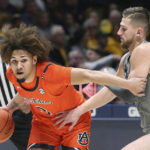 
              Auburn guard Tre Donaldson (3) is defended by West Virginia guard Erik Stevenson during the first half of an NCAA college basketball game on Saturday, Jan. 28, 2023, in Morgantown, W.Va. (AP Photo/Kathleen Batten)
            