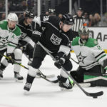 
              Los Angeles Kings center Jaret Anderson-Dolan (28) shoots backwards to Dallas Stars goaltender Scott Wedgewood, right, during the second period of an NHL hockey game Thursday, Jan. 19, 2023, in Los Angeles. (AP Photo/Ashley Landis)
            