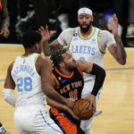 
              Los Angeles Lakers' Rui Hachimura, of Japan, left, and Anthony Davis, right, defend New York Knicks' Jalen Brunso, center, during overtime of an NBA basketball game Tuesday, Jan. 31, 2023, in New York. The Lakers won 129-123.(AP Photo/Frank Franklin II)
            