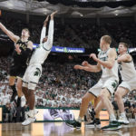 
              Purdue guard Braden Smith (3) makes a layup as Michigan State guard Tre Holloman (5) defends during the first half of an NCAA college basketball game, Monday, Jan. 16, 2023, in East Lansing, Mich. (AP Photo/Carlos Osorio)
            