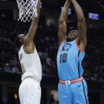 
              Phoenix Suns center Bismack Biyombo (18) shoots against Cleveland Cavaliers forward Evan Mobley during the first half of an NBA basketball game, Wednesday, Jan. 4, 2023, in Cleveland. (AP Photo/Ron Schwane)
            