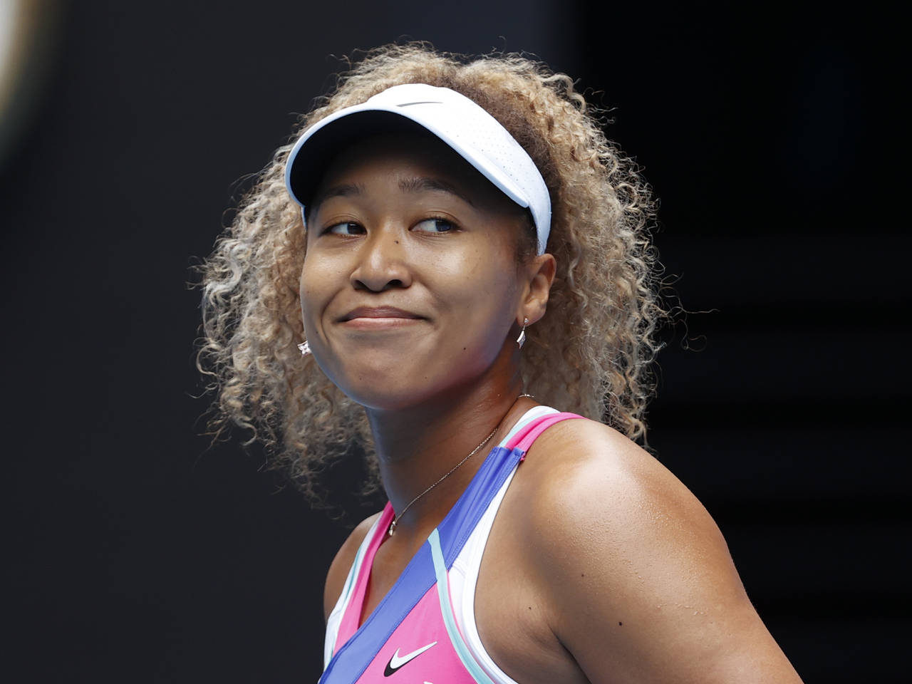 FILE - Naomi Osaka of Japan smiles during her first round match against Camila Osorio of Colombia a...
