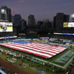 
              A U.S flag is rolled out onto the field before the Holiday Bowl NCAA college football game between North Carolina and Oregon Wednesday, Dec. 28, 2022, in San Diego. (AP Photo/Denis Poroy)
            