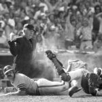 
              FILE - Umpire Tom Gorman signals out after Oakland Athletic's Sal Bando, left, collided with Los Angeles Dodgers catcher Steve Yeager at home plate during a baseball game in Los Angeles on Oct. 12, 1973. Bando, a three-time World Series champion with the Oakland Athletics and former Milwaukee Brewers executive, died Friday night, Jan. 20, 2023, in Oconomowoc, Wis., according to a statement from his family. He was 78. (AP Photo/File)
            
