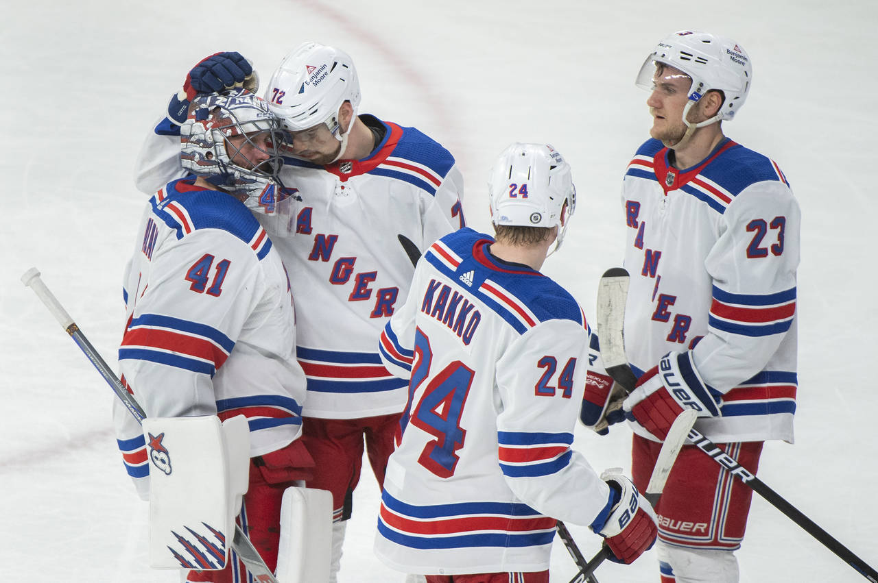 New York Rangers goaltender Jaroslav Halak (41) is congratulated by teammates after defeating the M...