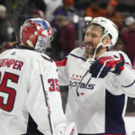 
              Washington Capitals left wing Alex Ovechkin, right, smiles as he celebrates a win over the Arizona Coyotes with goaltender Darcy Kuemper (35) for a shutout as time expires in the third period of an NHL hockey game in Tempe, Ariz., Thursday, Jan. 19, 2023. (AP Photo/Ross D. Franklin)
            