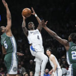 
              Brooklyn Nets' Edmond Sumner (4) shoots between Detroit Pistons' Alec Burks (5) and Isaiah Stewart (28) during the first half of an NBA basketball game Thursday, Jan. 26, 2023 in New York. (AP Photo/Frank Franklin II)
            