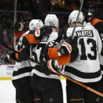 
              Philadelphia Flyers right wing Wade Allison (57) celebrates his goal against the Washington Capitals with center Kevin Hayes (13) and others during the second period of an NHL hockey game Saturday, Jan. 14, 2023, in Washington. (AP Photo/Nick Wass)
            