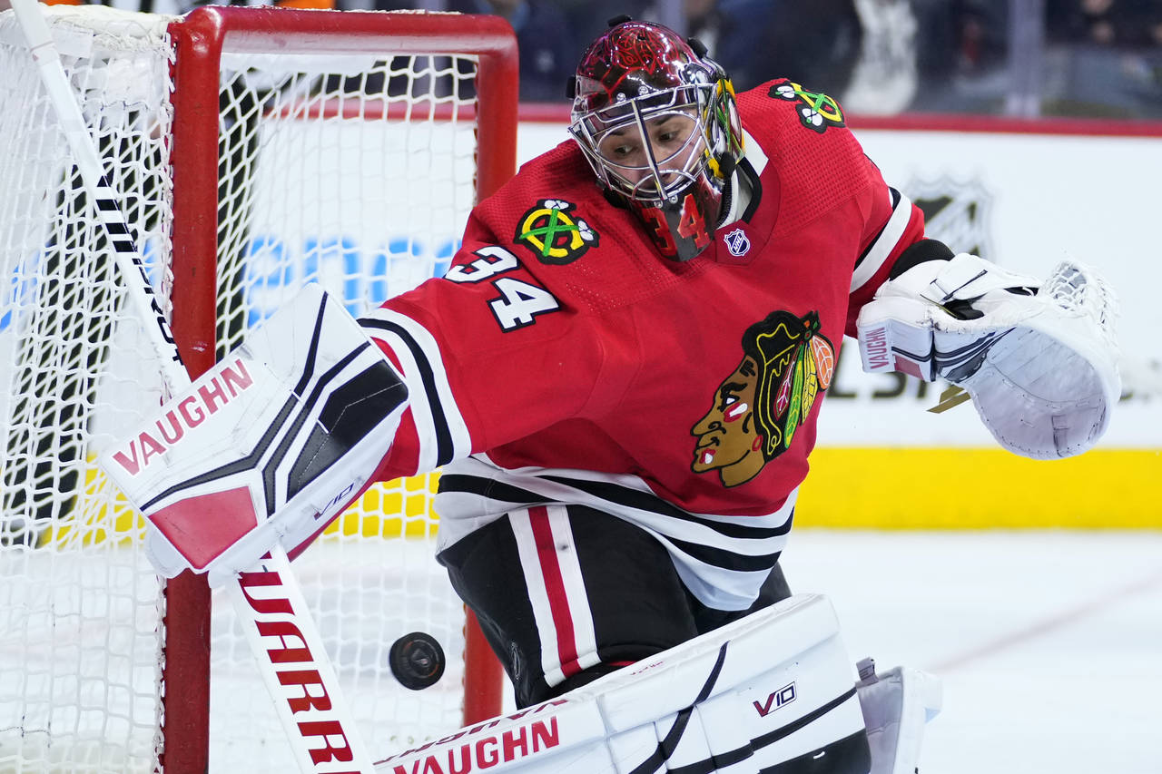 Chicago Blackhawks' Petr Mrazek deflects a shot during the second period of an NHL hockey game agai...