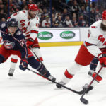 
              Carolina Hurricanes defenseman Brent Burns, right, controls the puck in front of Columbus Blue Jackets forward Patrik Laine, left, and Hurricanes forward Jordan Martinook during the second period of an NHL hockey game in Columbus, Ohio, Thursday, Jan. 12, 2023. (AP Photo/Paul Vernon)
            